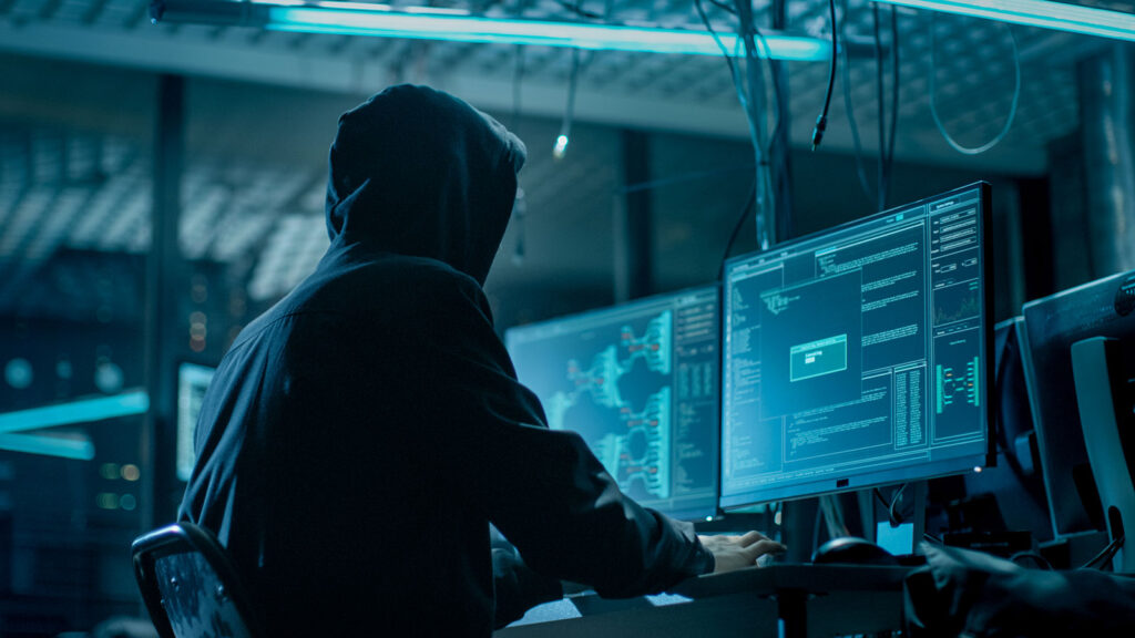 Attacker in a hoodie, symbolizing external threats and the need for actionable vulnerability intelligence and prioritization.